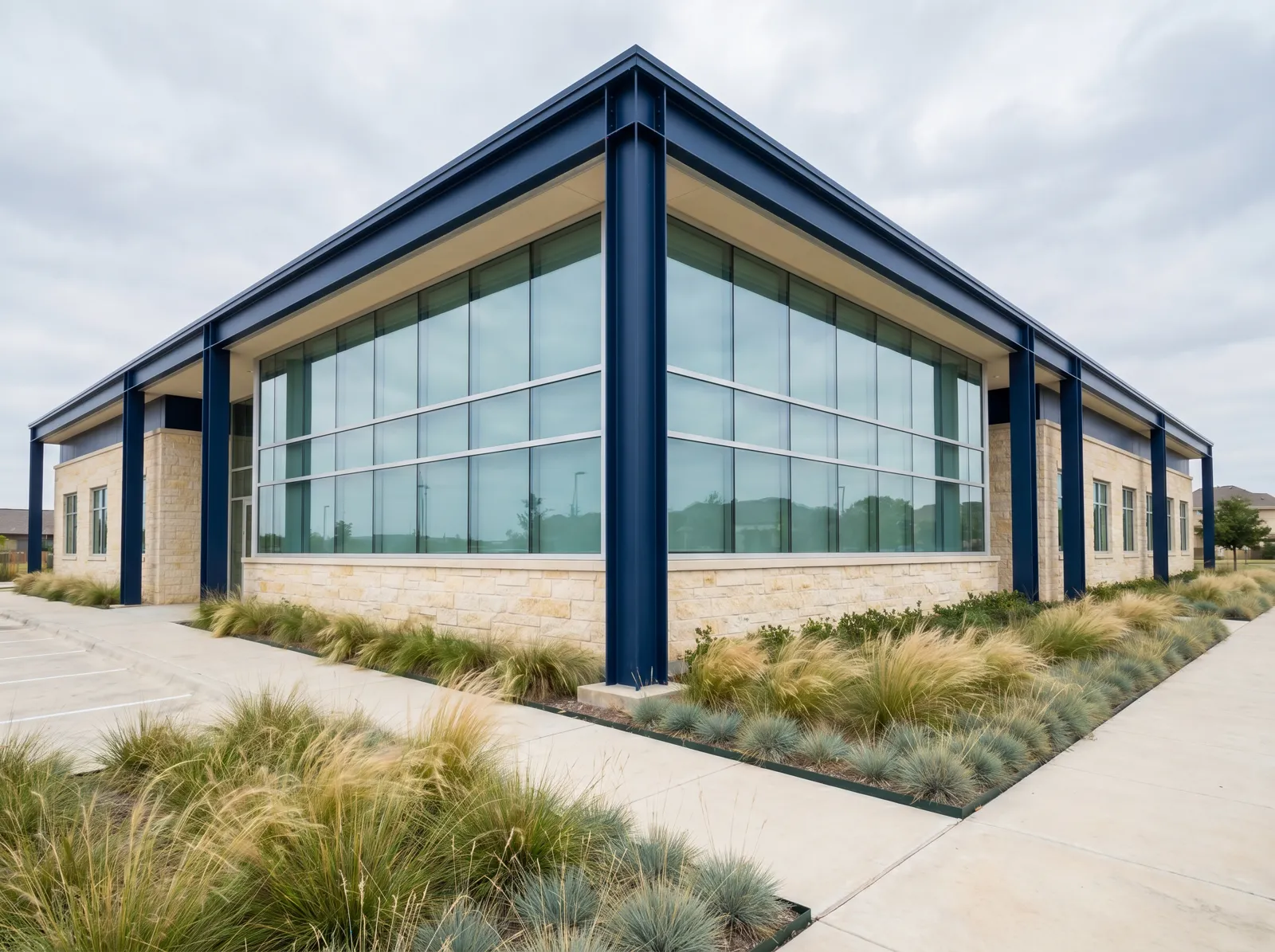 Modern office building exterior with stone base and navy steel accents, illustrative of St. Ives Realty's office holdings