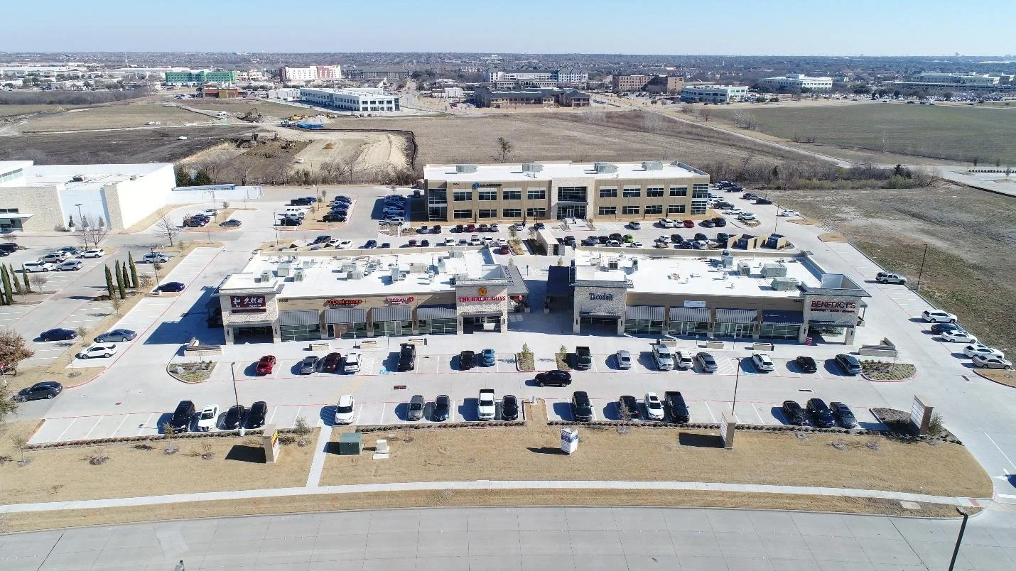 Aerial view of the Parkwood Village retail center with tenant storefronts, Plano, Texas