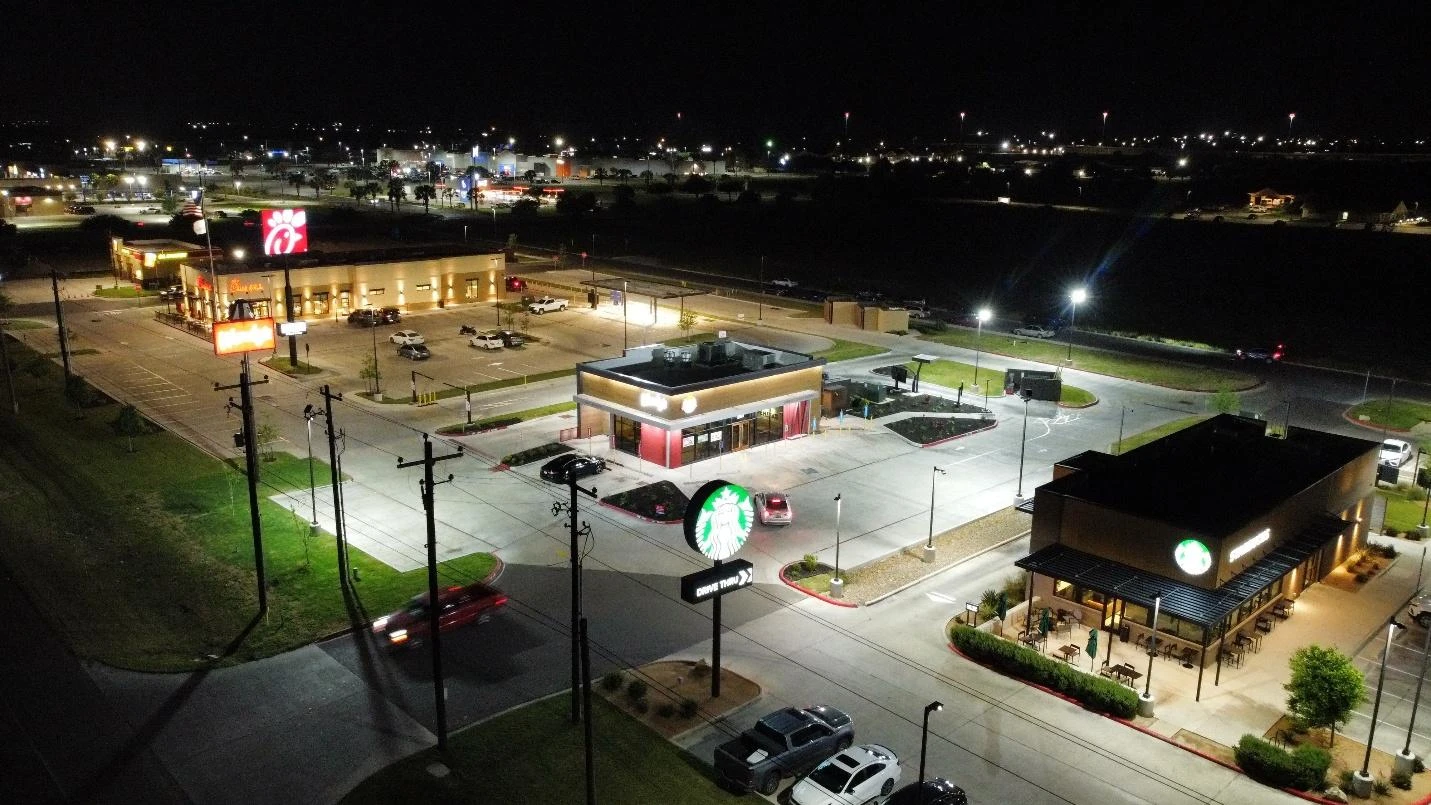 Night aerial view of Peñitas Village with Chick-fil-A and Starbucks pad sites, Peñitas, Texas